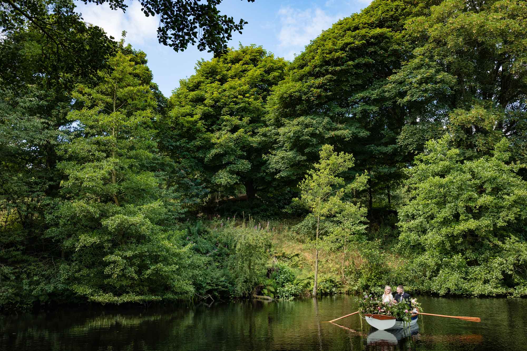 Couple rowing the wedding boat