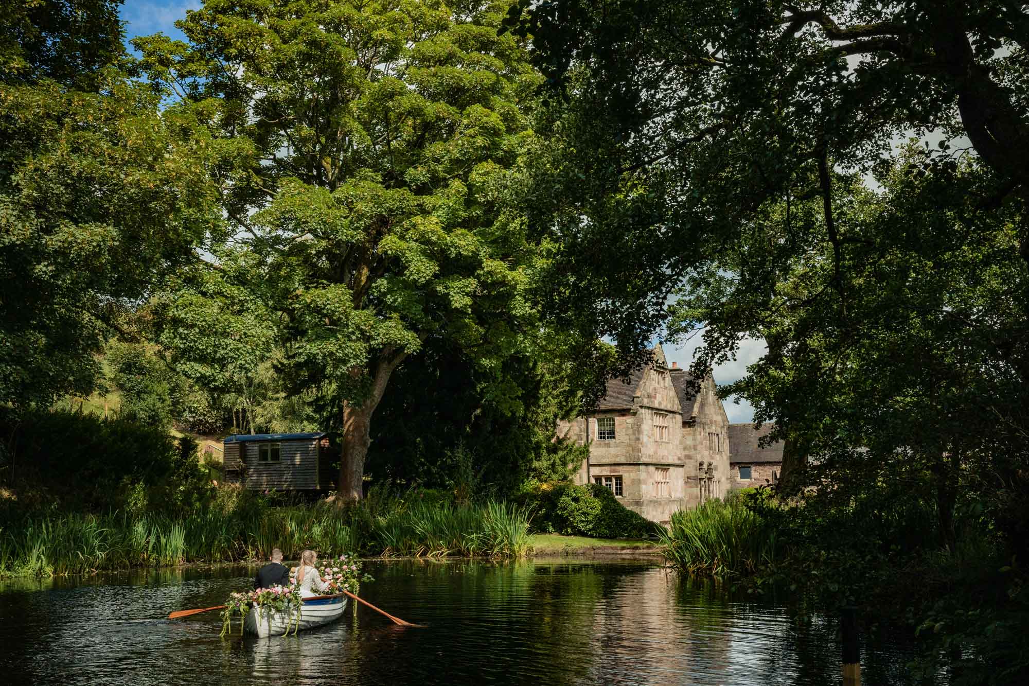 Couple rowing the wedding boat