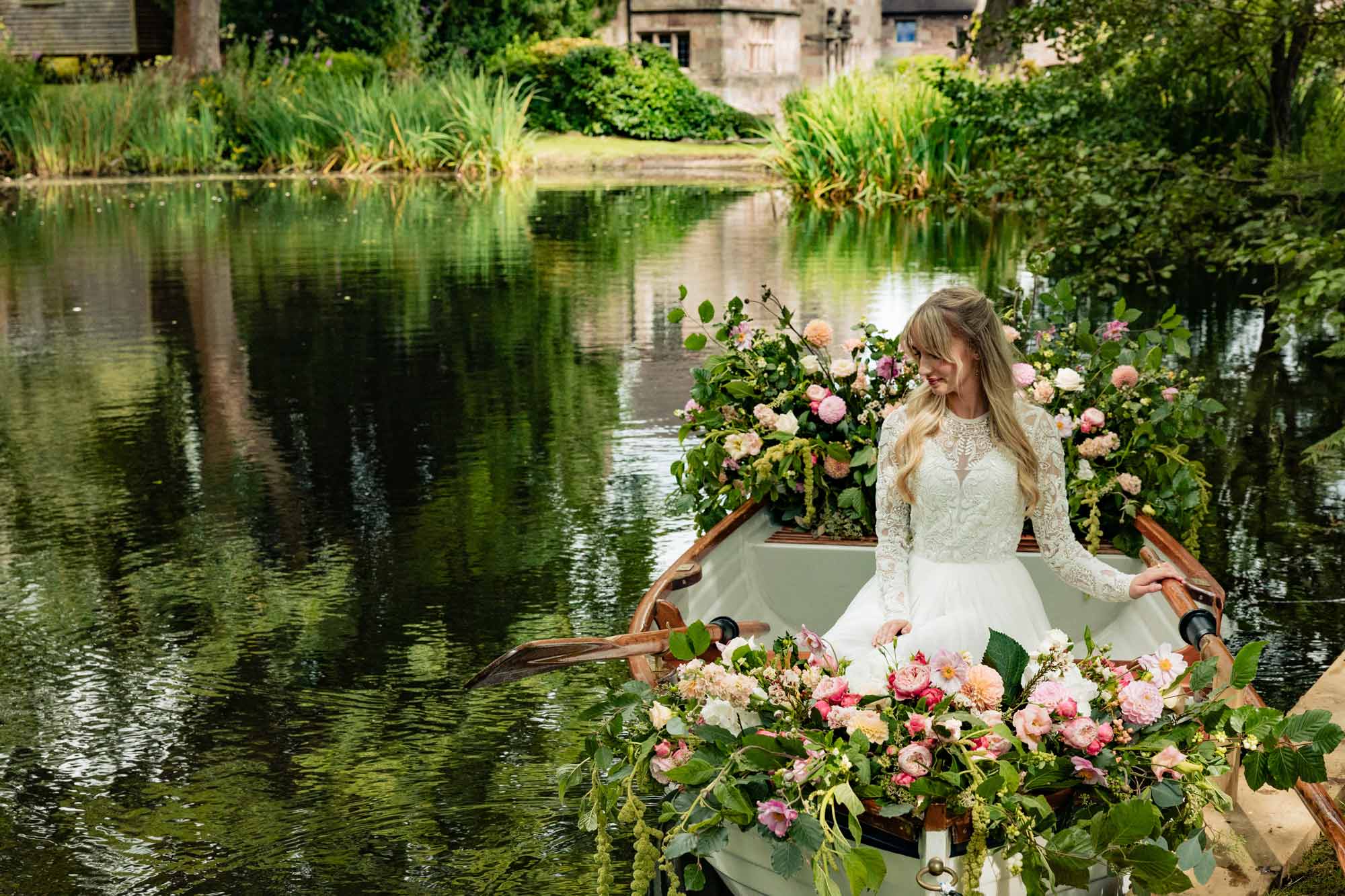 Wedding rowing boat with bride and floral display